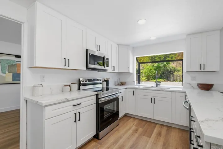 New cabinets, new countertops, new stainless steel appliances - stove, microwave, dishwasher.