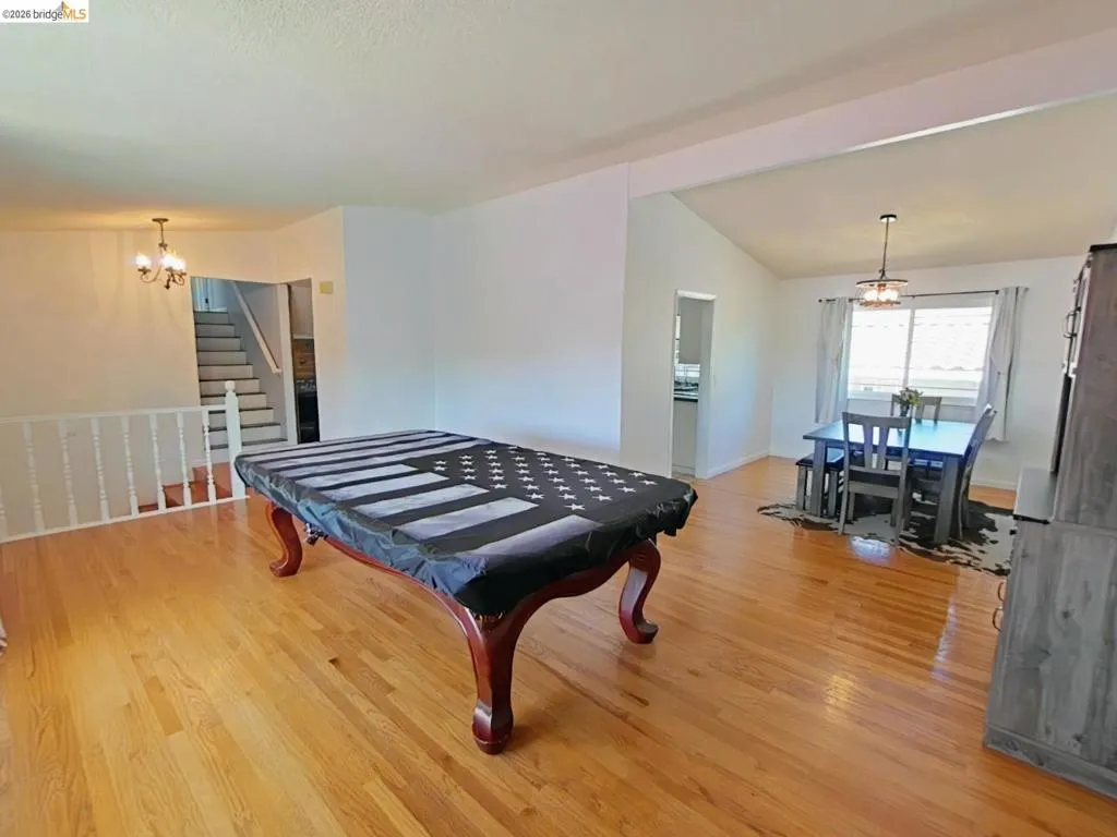 Open-concept living space with wood-finish flooring throughout