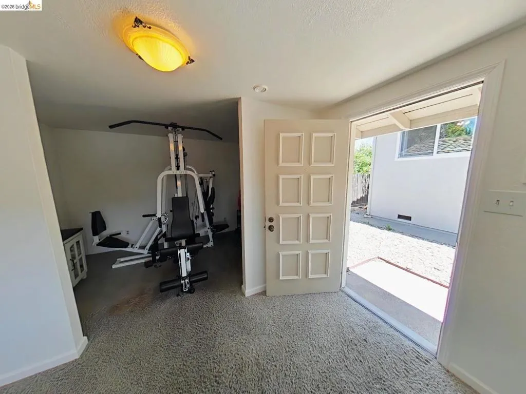 Interior space featuring light-colored carpeting and a flush-mounted ceiling light fixture