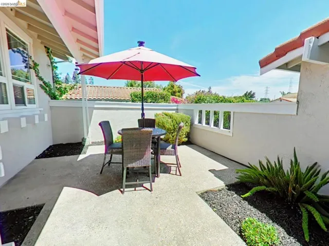 Private outdoor patio featuring a concrete surface and integrated landscaping