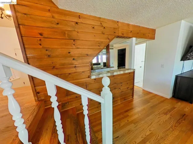 Hardwood flooring and staircase with white spindles