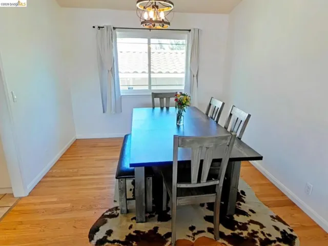 Wood-finish flooring with white baseboards