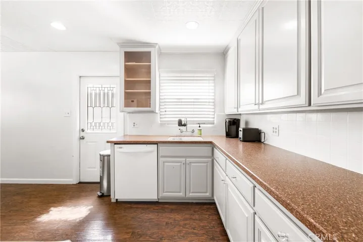 Kitchen has a side entrance to the backyard.