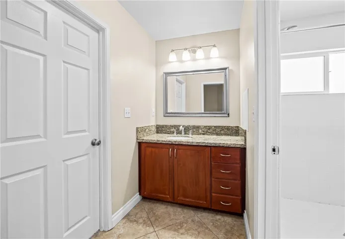 Bathroom #3 – Dedicated vanity area featuring a single-sink and convenient access to the adjoining shower and toilet.