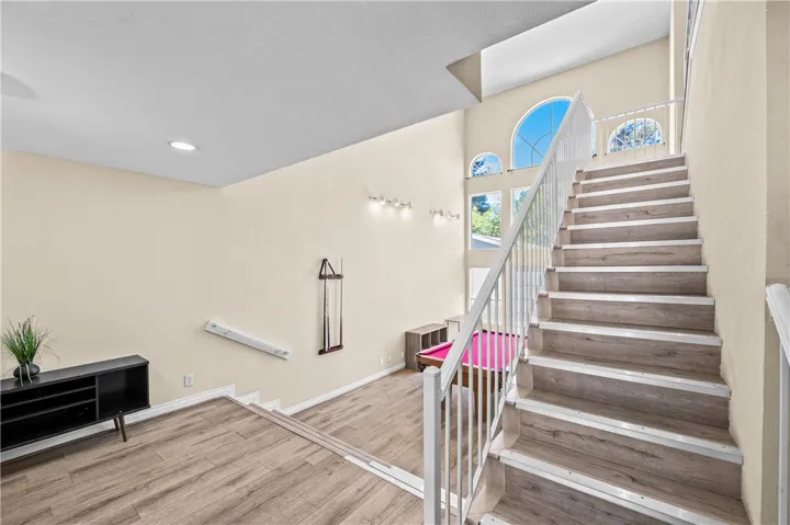 Open staircase and landing create an inviting second-floor living space.