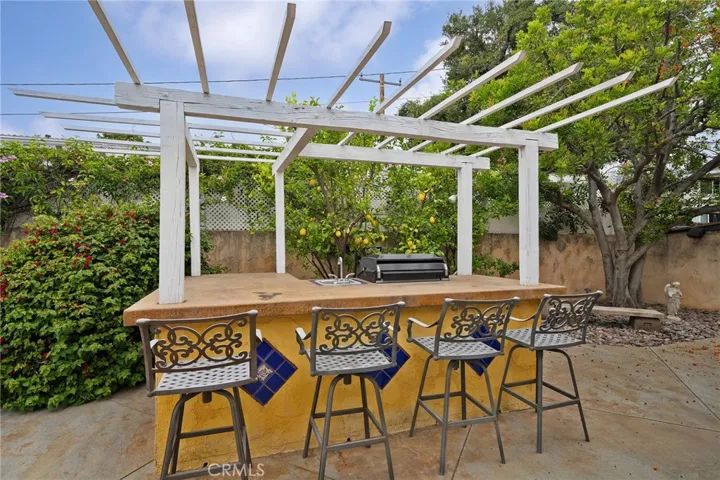 Entertaining bar with built-in BBQ area and sink.