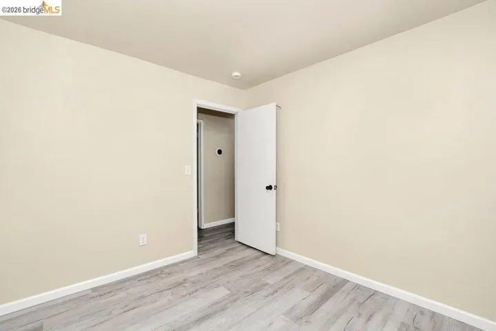 Neutral tone wall finish and wood-finish flooring