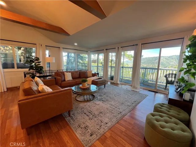 Spacious living room with view out the full wall of windows