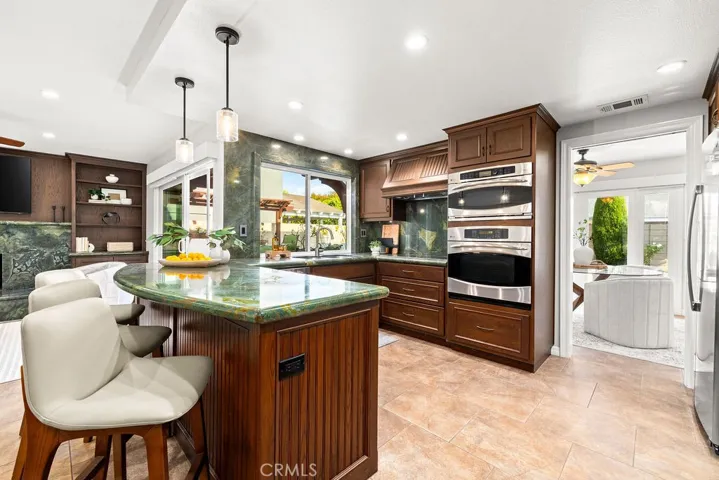 Kitchen Granite Counter top with Extra Seating and view of Stainless Steel Appliances
