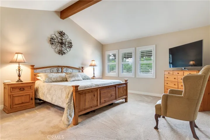 Primary Suite with wonderful beamed ceilings and plantation shutters