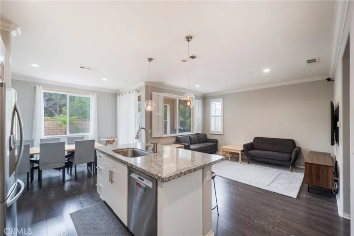 Kitchen opens up to the living room and patio to the backyard.