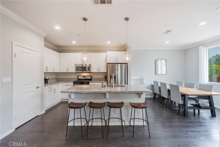 Open concept kitchen with many cabinets, storage pantry, newer appliances.