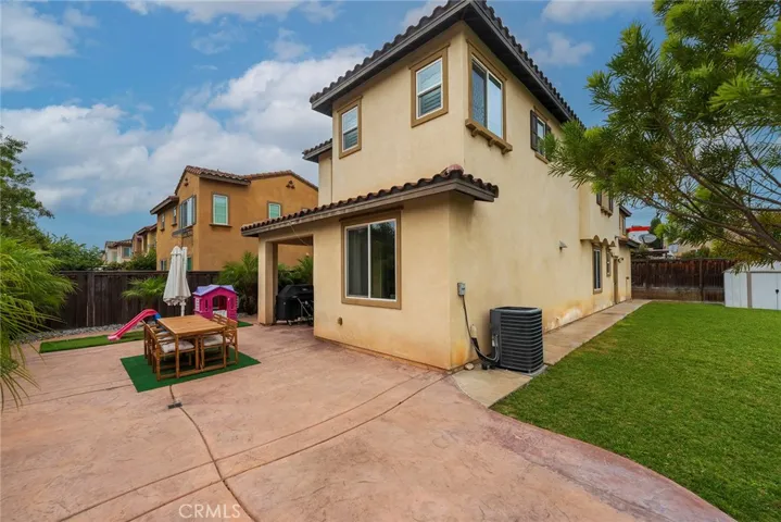  Hardscape leads to patio near kitchen, dining area, and living room.