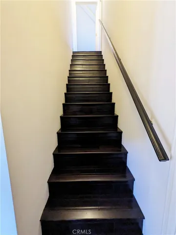 Back staircase between family room and downstairs bedroom