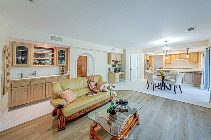 Elegant family room featuring a wet bar and custom built-in wine display