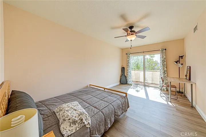 The third bedroom offers a ceiling fan and direct access to a private balcony