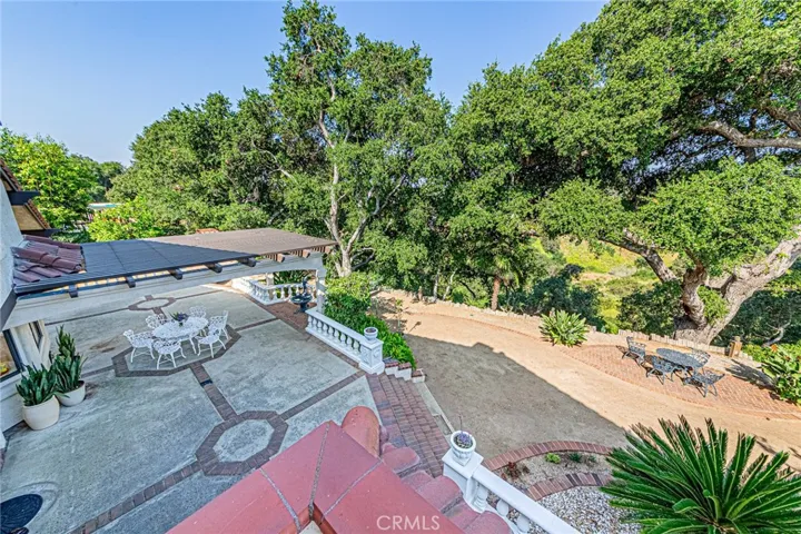 Serene backyard with a gentle slope leading directly to scenic walking trails