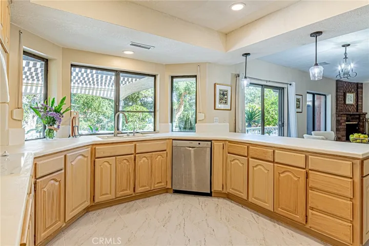 Spacious, well-appointed kitchen with serene backyard views