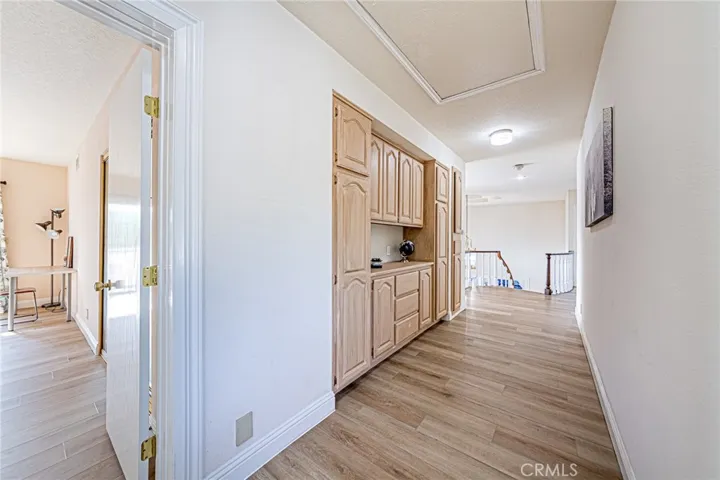 Bright upper hallway enhanced with custom built-in cabinets for organization and convenience