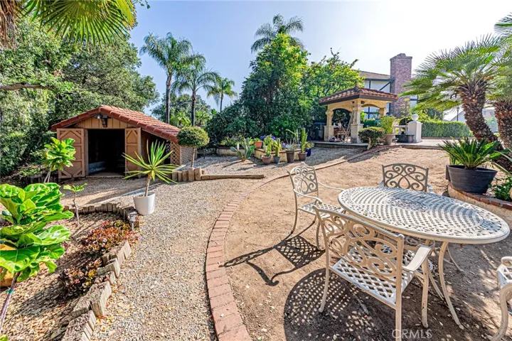 Backyard featuring a gazebo and custom storage shed for extra space