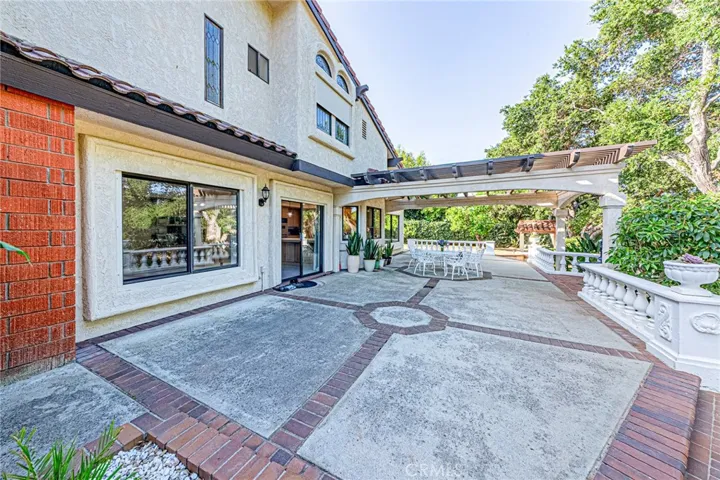 Expansive backyard featuring a covered patio ideal for outdoor living and entertaining