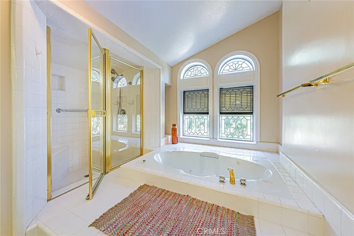 Bathroom featuring a jacuzzi tub and separate shower