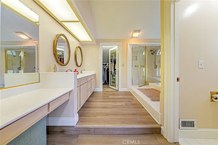 Primary suite designed with generous storage, including a walk-in closet and secondary closet
