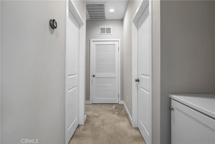 Hallway to primary and guest bedroom and guest bathroom