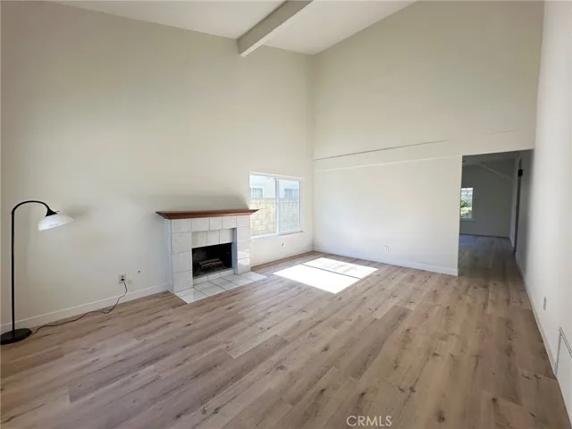Living Room- high ceilings, bright and open, new LVP flooring, new texture paint, new double paned windows throughout