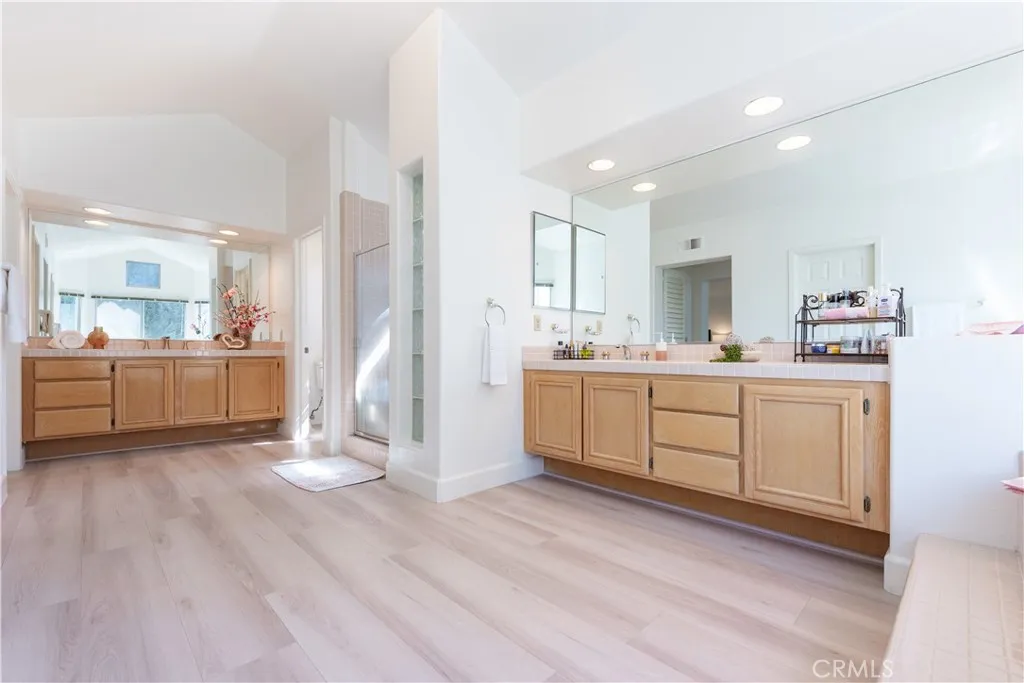 Primary bathrooms-- dual vanities. stall shower