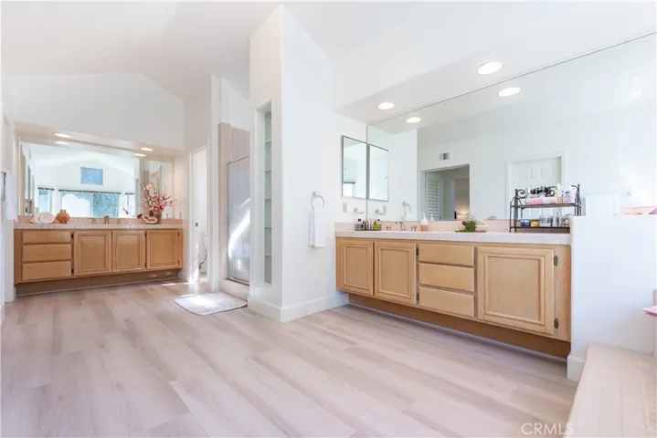Primary bathrooms-- dual vanities. stall shower