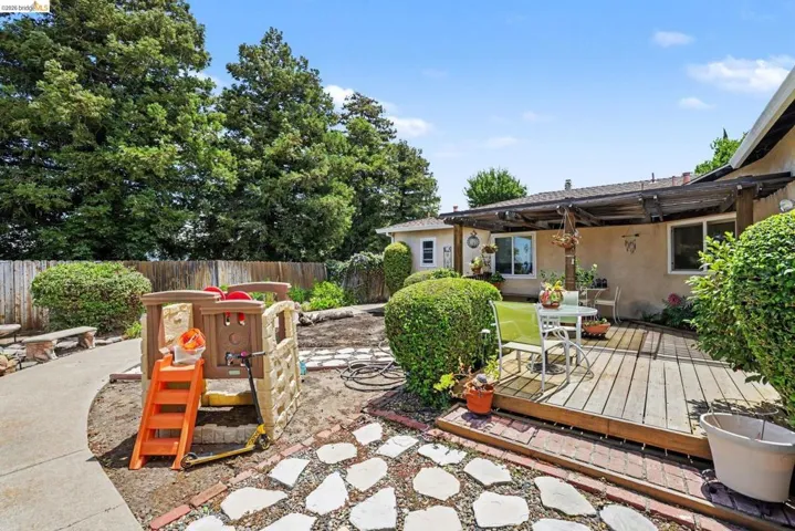 Wood deck patio with an overhead pergola structure