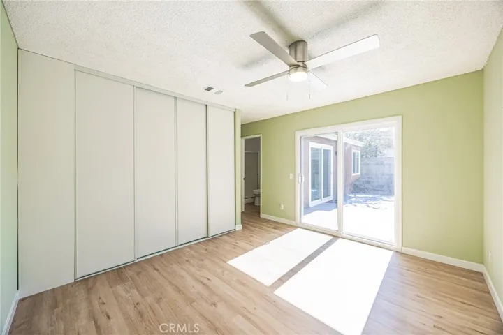 Primary Bedroom with sliding door to backyard