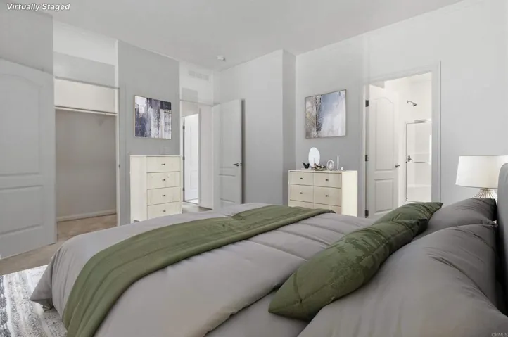 Virtually Staged Primary Bedroom with Walk-in Closet - see original photo