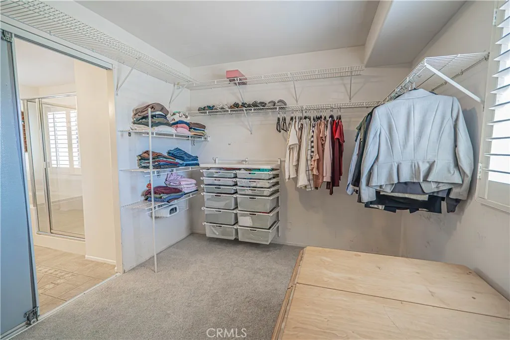 Spacious Walk in Primary Closet with elfa organizers