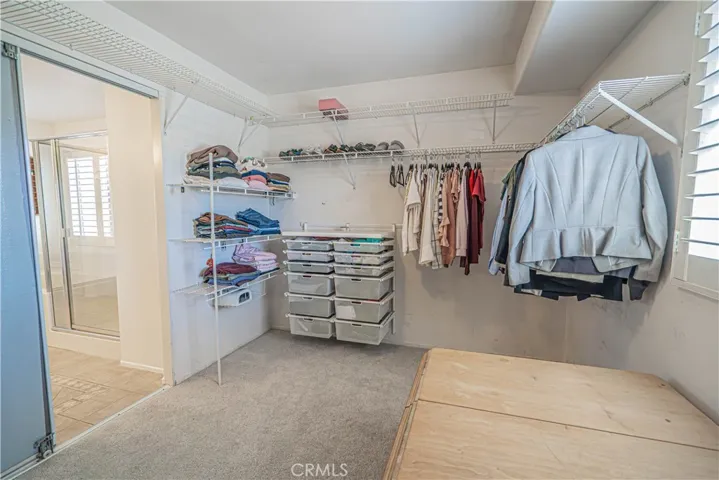 Spacious Walk in Primary Closet with elfa organizers