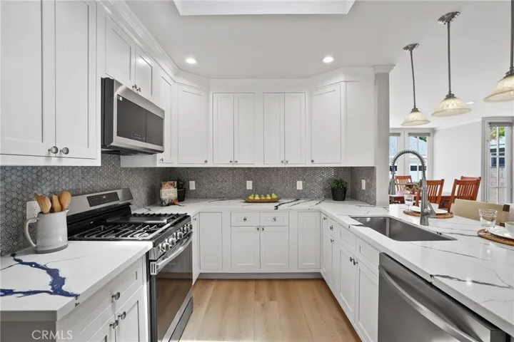 Tile backsplash accents the appliances perfectly.