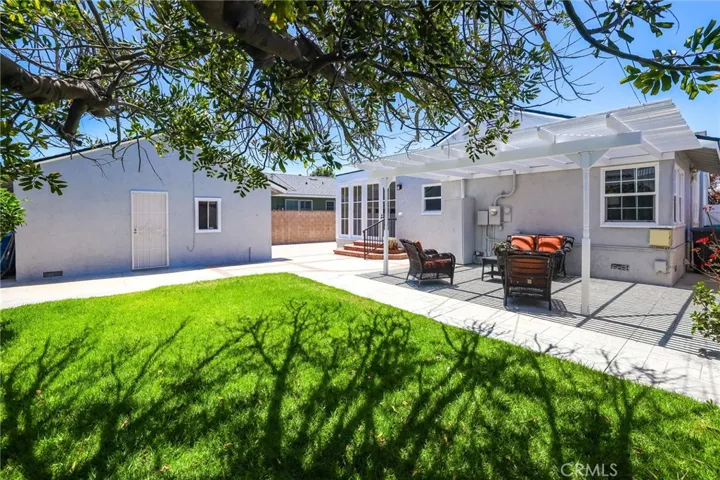 The immaculate backyard view of the patio and detached garage give a peaceful relaxing vibe.