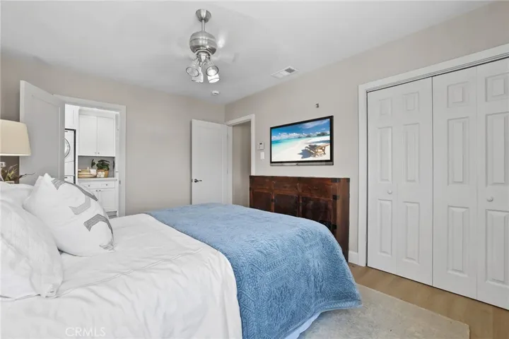 Corner view of the primary bedroom with access to the en suite.