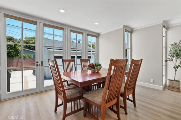 Dining room is bright and airy with views of the backyard through the french doors.