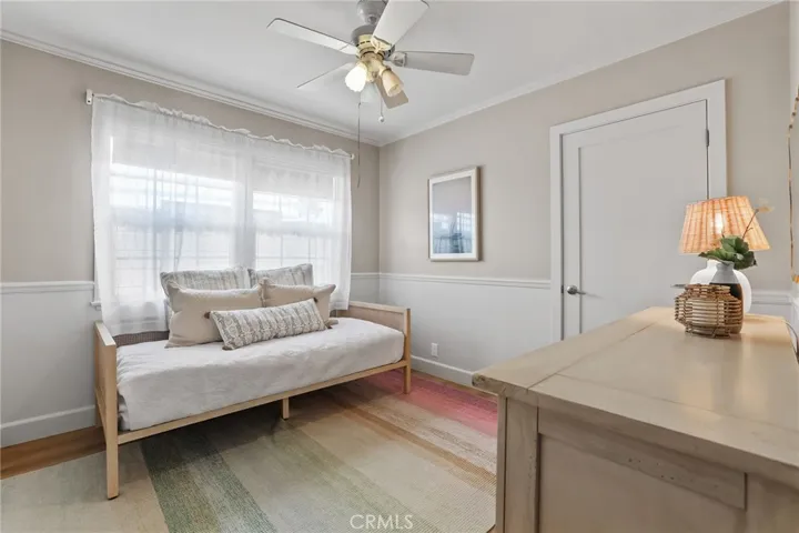 Guest bedroom #2 has large window with view of the side of the house. Wainscot/chair railing accent the walls.  Large closet.