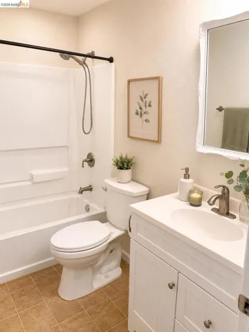 Full bathroom featuring a white tub and shower combination with a curved shower rod