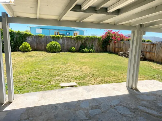 Patio with stone-finish flooring and a covered wood beam structure