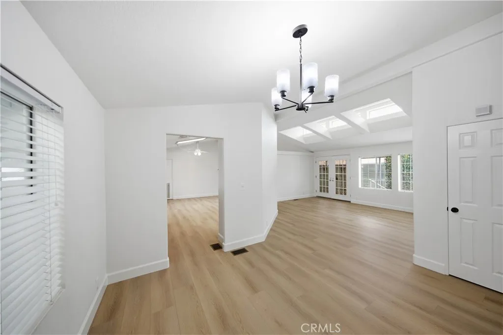 Dining room with new flooring and new light fixture.