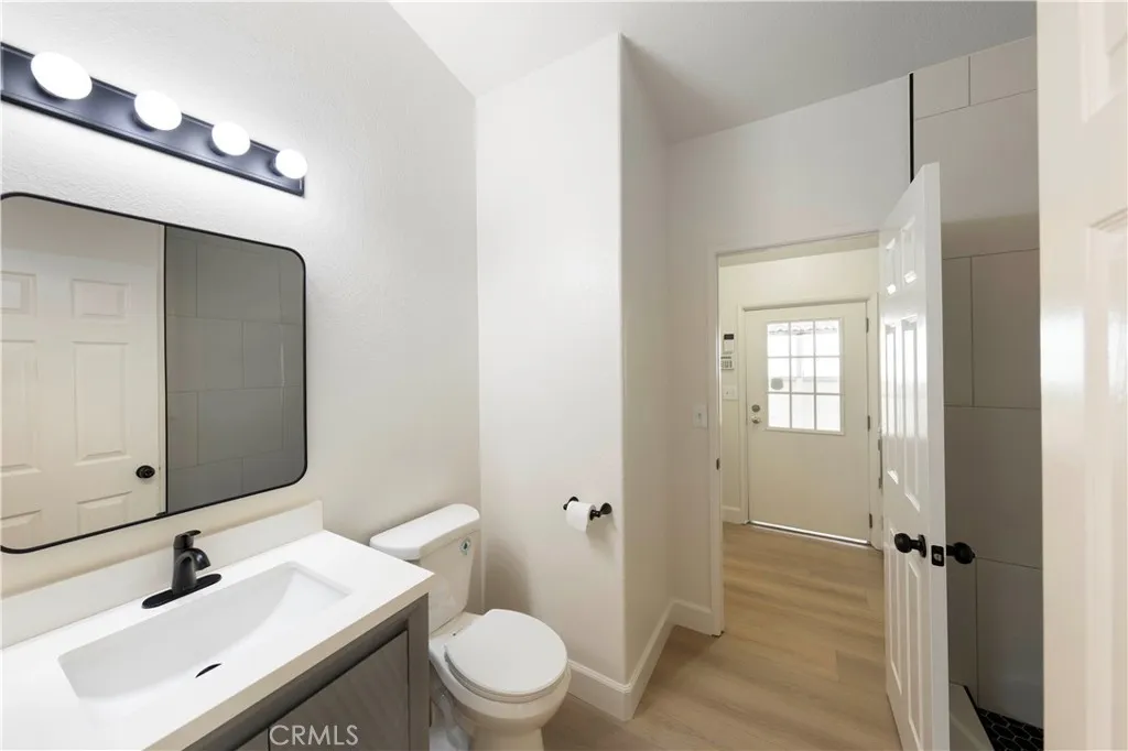Bathroom 2 with new walk-in shower, vanity and sink, mirror and light fixture.