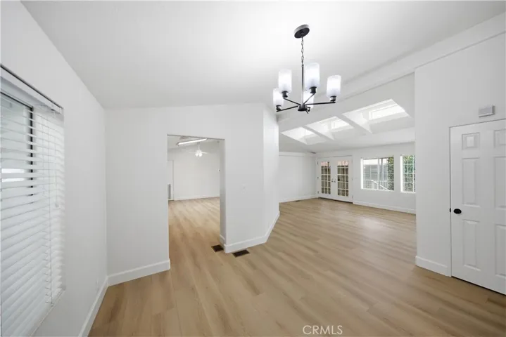 Dining room with new flooring and new light fixture.