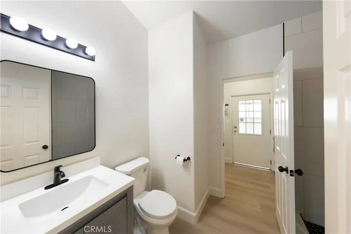 Bathroom 2 with new walk-in shower, vanity and sink, mirror and light fixture.