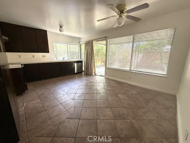 Kitchen open to dining area with ceiling fan