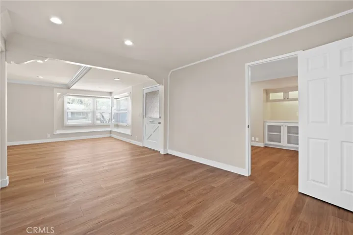 View of office door and entry door from kitchen.