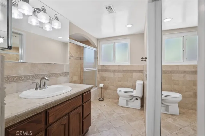 Primary bathroom has beautiful stone tile.